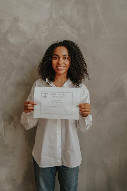 A joyful woman proudly displays an adoption certificate.