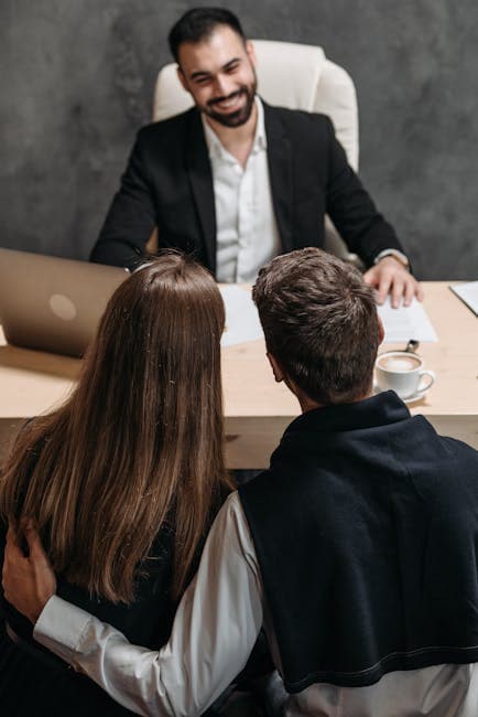 A couple consults a professional in an office setting, discussing important matters.