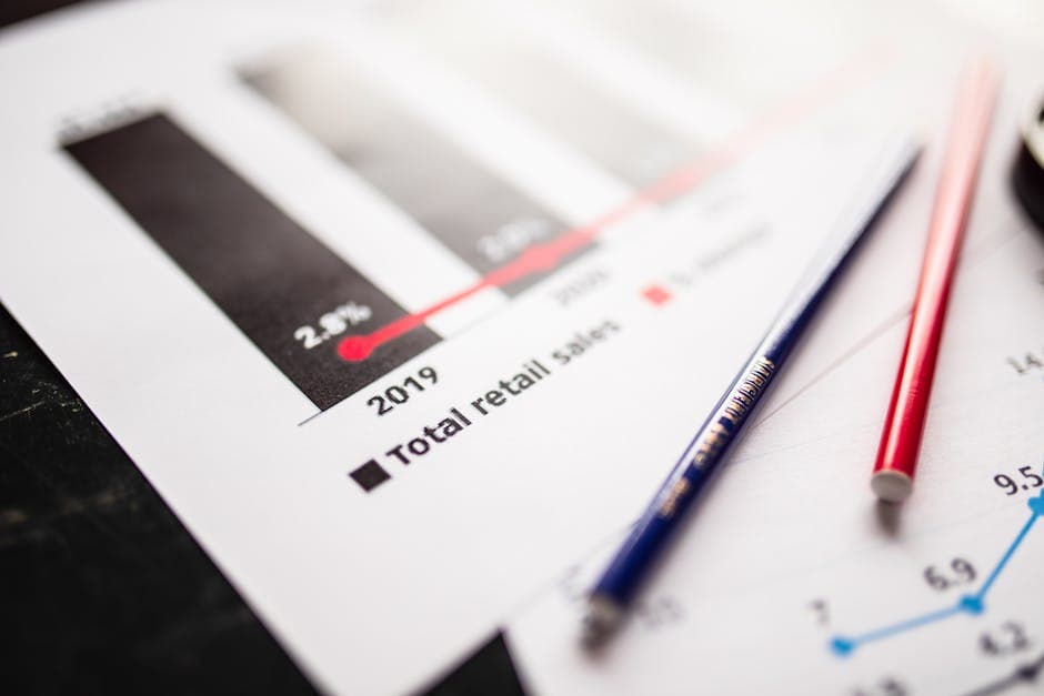 Detail view of retail sales chart and pencils on desk, showcasing data analysis.