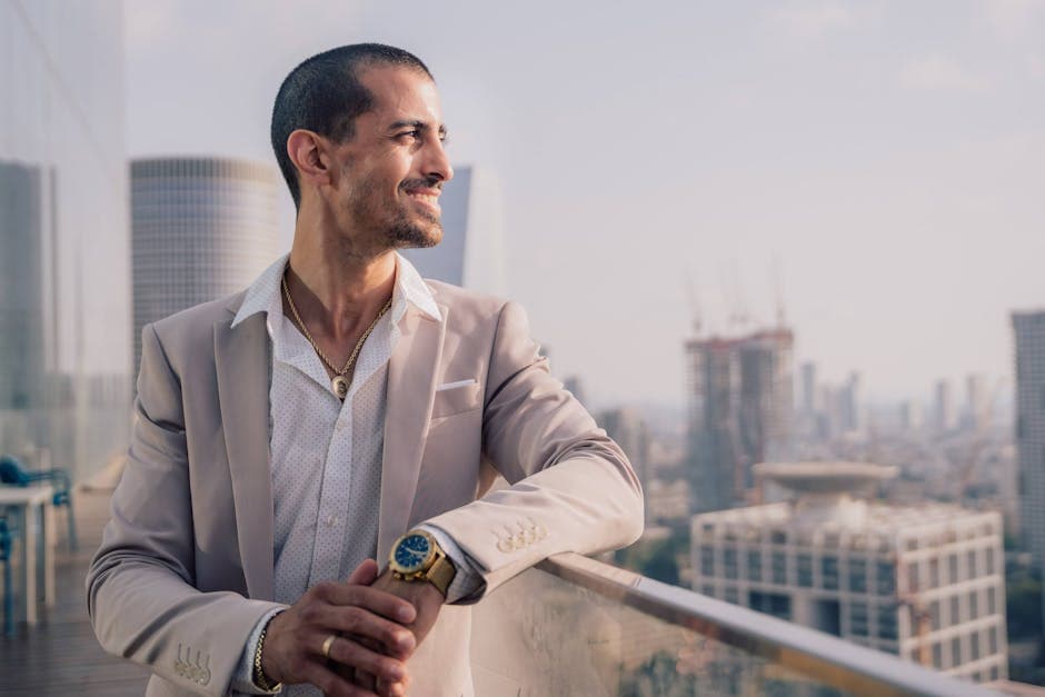Confident man in a suit enjoying the view of a modern city skyline from a balcony terrace.